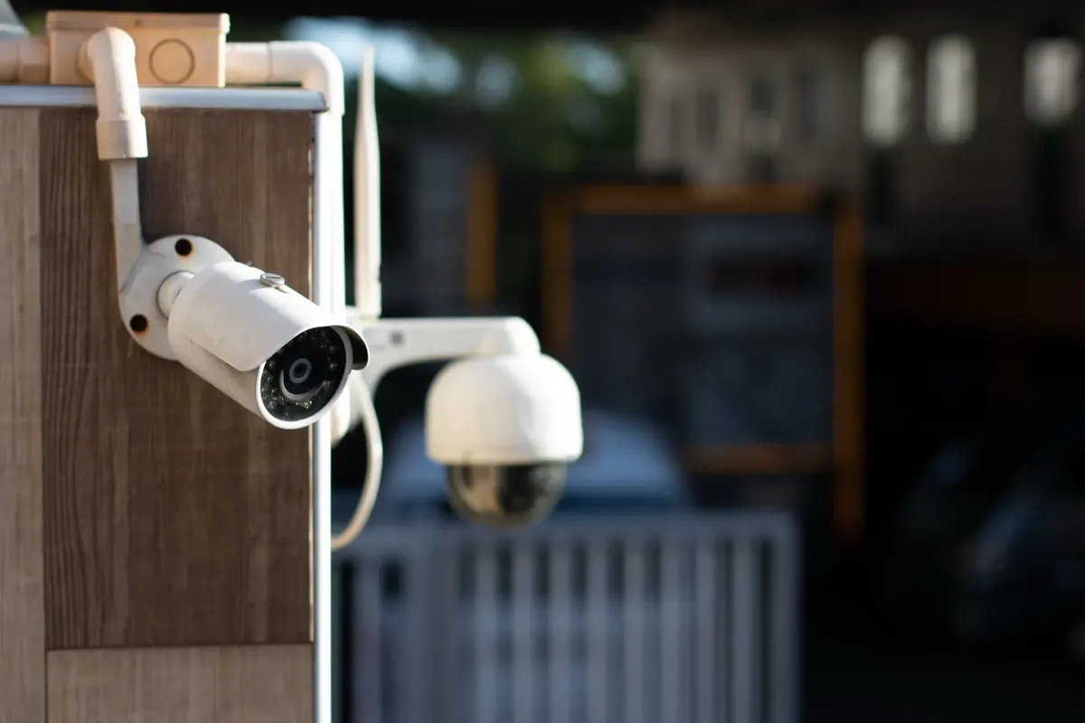 Bullet and dome CCTV cameras on the outside of a building