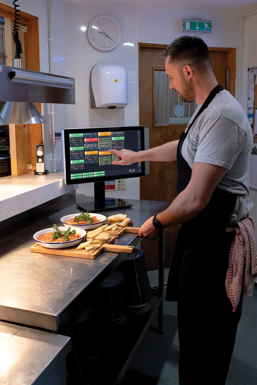Chef using a kitchen display screen
